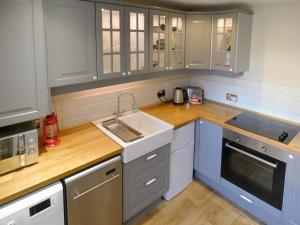 a kitchen with a sink and a counter top at The Old Clockmakers in Pateley Bridge