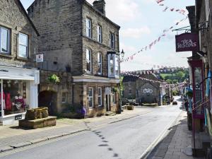 an empty street in an old town with buildings at The Old Clockmakers in Pateley Bridge