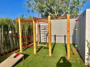 un parque infantil en un patio con un columpio en Theme - Taghazout - Luxury villa - 10 Px, en Taghazout