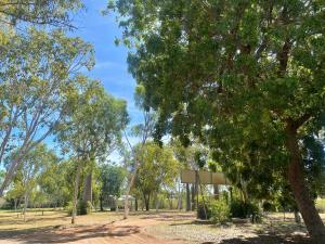 a park with trees and a basketball hoop at Lily Lagoon Resort in Kununurra