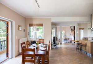 a dining room and kitchen with a table and chairs at Villa Victoria - 3 Bedroom Villa With a Private Pool in Katokhórion