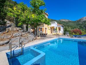 a swimming pool in front of a house at Villa Victoria - 3 Bedroom Villa With a Private Pool in Katokhórion