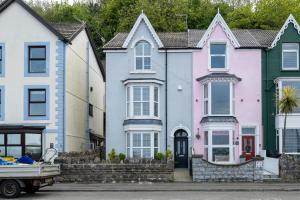 a row of colorful houses on a street at Sea View 4 Bedroom Property in Mumbles in The Mumbles