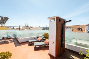a balcony with chairs and tables on a roof at Ambassador River Shower Suites in Lisbon +23 photos