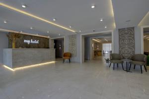 a lobby of a hotel with chairs and a reception desk at My Hotel Bishkek in Bishkek