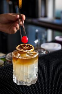 a person is preparing a drink on a table at The Embassy Valletta Hotel in Valletta
