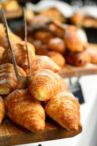 a pile of croissants and other pastries on a table at The Embassy Valletta Hotel in Valletta