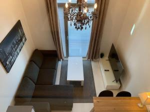 a living room with a couch and a chandelier at Viihtyisä koti in Vantaa