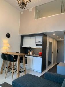 a kitchen with a table and chairs in a room at Viihtyisä koti in Vantaa