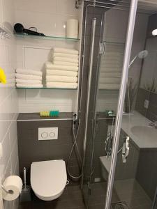 a bathroom with a toilet and a shower with towels at Viihtyisä koti in Vantaa