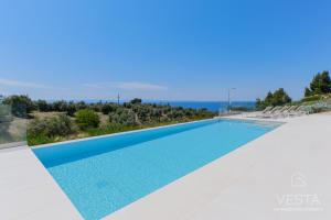 a swimming pool in a villa with a view at Olive Grove Suites - Villas with private pool and garden in Nikiti