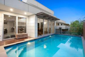 a swimming pool in front of a house at Marvellous Montfort in Blairgowrie
