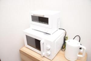a white computer system sitting on top of a table at NY Cottage（コテージ） in Tokyo