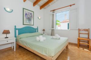 a bedroom with a bed with two towels on it at Son Xoriguer 14 in Son Xoriguer +17 photos