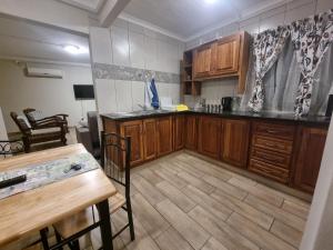 a kitchen with wooden cabinets and a wooden table at Hoep Hoep Self Catering in Groblersdal