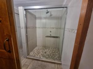 a shower with a glass door in a bathroom at Hoep Hoep Self Catering in Groblersdal