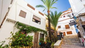 a building with a palm tree in front of it at Villa Alejandria in Moraira
