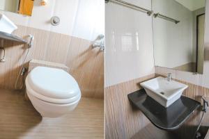 a bathroom with a white toilet and a sink at FabHotel Archanil Apartment in Nagpur