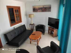 a living room with a couch and a tv at vilanova-beach in Vilanova i la Geltrú