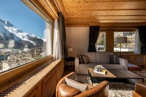 a living room with a view of a mountain at Hotel Steffani in St. Moritz