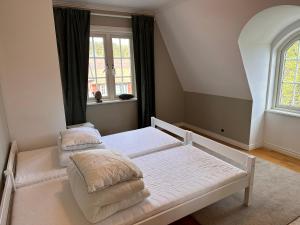 a bedroom with a bed and a window at Oxgården in Vimmerby