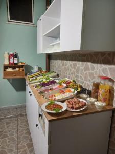 a kitchen counter with many plates of food on it at Emirhan Inn Hotel & Suites in Istanbul