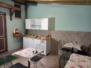 a room with two tables and a kitchen with a counter at Emirhan Inn Hotel, Sultanahmet in Istanbul