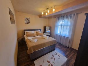 a bedroom with a large bed and a window at Apartment Niko in Senj