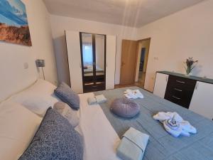 a bedroom with a large bed with towels on it at Apartment Niko in Senj +56 photos