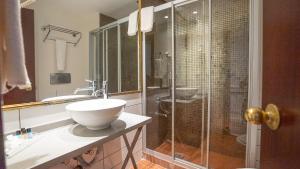 a bathroom with a sink and a glass shower at Seminal Hotel Taksim in Istanbul