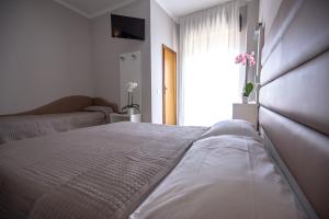 Postel nebo postele na pokoji v ubytování Hotel Susy