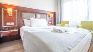 Un pat sau paturi într-o cameră la Seminal Hotel Taksim