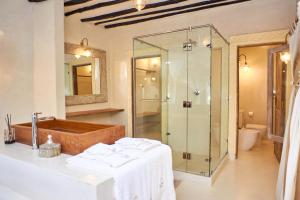a bathroom with a glass shower and a sink at Alawi Home in Watamu