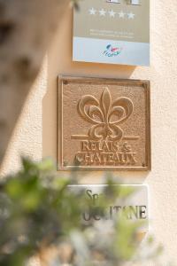 a sign on a wall that reads metals chemicals at La Bastide de Saint Tropez in Saint-Tropez