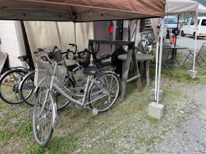 a group of bikes parked under a tent at Nori's Sharehouse Hakuba in Hakuba