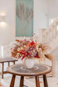 a vase filled with flowers on a table at La Bastide de Saint Tropez in Saint-Tropez