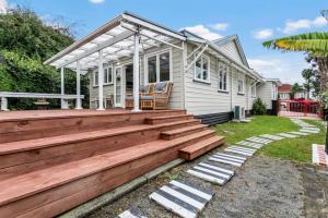 a house with a wooden deck in front of it at Spacious Family Retreat in City - Netflix - WiFi in Auckland