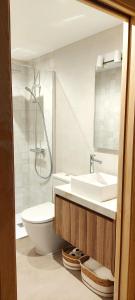 a bathroom with a sink and a toilet and a shower at Villa Es Socorrat in Na Xamena