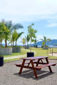 a picnic table in a park with palm trees at Homesuite' Home at Jesselton Quay in Kota Kinabalu