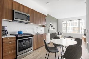 a kitchen with a table and a kitchen with a microwave at S Lake Union 1BR w Gym WD nr Whole Foods SEA-2 in Seattle