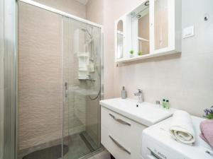 a white bathroom with a shower and a sink at Apartment Anka in Dubrovnik +77 photos