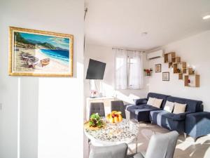 a living room with a blue couch and a table at Apartment Anka in Dubrovnik