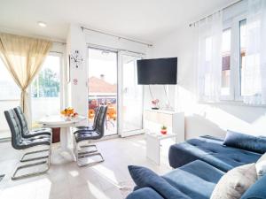 a living room with a blue couch and a table at Apartment Anka in Dubrovnik