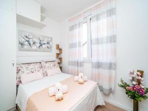 a bedroom with a bed with hello kitty towels on it at Apartment Anka in Dubrovnik