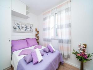 a bedroom with a purple bed with purple pillows at Apartment Anka in Dubrovnik