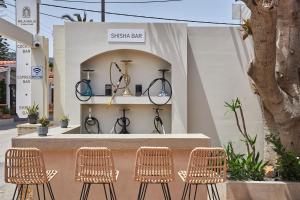a group of chairs sitting in front of a store at Mila Malia Studios Hotel in Malia +159 photos