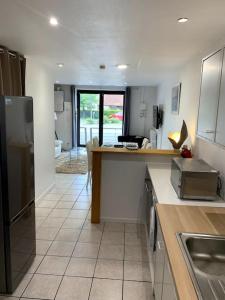 a kitchen with a sink and a counter top at Gîte des Anciennes Salines Nationales in Montmorot