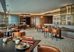 a restaurant with tables and chairs in a room at Oasis Aurum 181 Hotel in Hong Kong