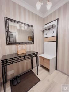 a dressing room with a table and a mirror at RentHouse Apartments Elegant in Chişinău