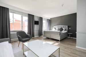 a living room with a bed and a couch at Hotell Arkad in Västerås